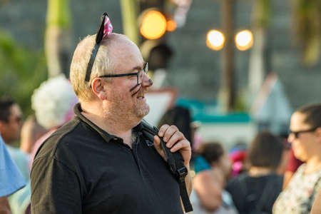 SANTA CRUZ DE TENERIFE, SPAIN - FEBRUARY 25, 2020: Around the Coso parade - along the Avenida de Anaga, official end of Carnival. Amazing warm evening, joyful people in carnival costumes have fun.のeditorial素材