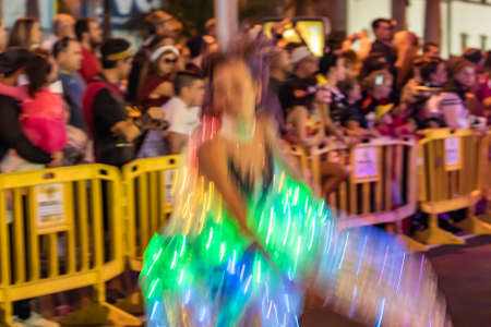 SANTA CRUZ DE TENERIFE, SPAIN - FEBRUARY 25, 2020: Around the Coso parade - along the Avenida de Anaga, official end of Carnival. Amazing warm evening, joyful people in carnival costumes have fun.のeditorial素材