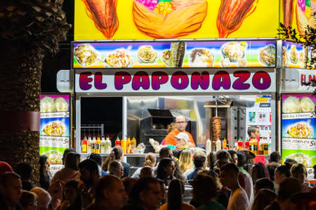 SANTA CRUZ DE TENERIFE, SPAIN - FEBRUARY 25, 2020: Around the Coso parade - along the Avenida de Anaga, official end of Carnival. Amazing warm evening, joyful people in carnival costumes have fun.のeditorial素材