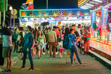 SANTA CRUZ DE TENERIFE, SPAIN - FEBRUARY 25, 2020: Around the Coso parade - along the Avenida de Anaga, official end of Carnival. Amazing warm evening, joyful people in carnival costumes have fun.のeditorial素材