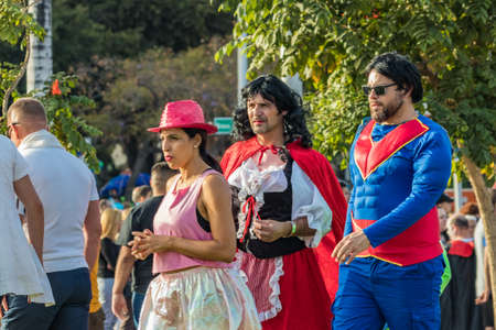 SANTA CRUZ DE TENERIFE, SPAIN - FEBRUARY 25, 2020: Around the Coso parade - along the Avenida de Anaga, official end of Carnival. Amazing warm evening, joyful people in carnival costumes have fun.のeditorial素材