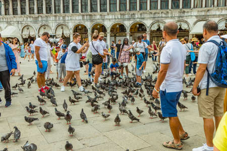 St. Mark Square, VENICE, ITALY - August 02, 2019: Warm sunny summer day. Numerous tourists are...
