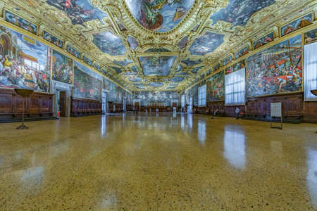 VENICE, ITALY - August 02, 2019: Interior of Doge`s Palace - Palazzo Ducale, the Senate Chamber. Doge`s Palace is one of the main tourist attractions in Venice. Visitors walk inside the Museum.のeditorial素材