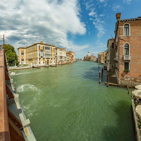 VENICE, ITALY - August 02, 2019: One of the thousands of lovely cozy corners in Venice on a clear sunny day. Historical buildings and canals with moored boats, Square frame.のeditorial素材