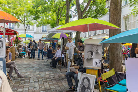 PARIS, FRANCE - JUNE 23, 2016: Summit of the butte Montmartre - highest point in the Paris. Favorite place for numerous tourists, art connoisseurs, local artists, musicians. People admire the beautiesのeditorial素材