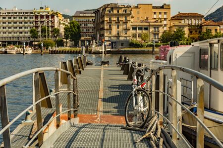 Como, ITALY - August 4, 2019: Marina in the Lake Como in the center of beautiful Italian Como city. Warm sunny summer day in very popular holiday destination.の写真素材