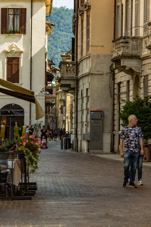 Como, ITALY - August 4, 2019: Local people and tourists on a quiet cozy streets in the center of beautiful Italian Como city. Warm sunny summer day in very popular holiday destination.のeditorial素材