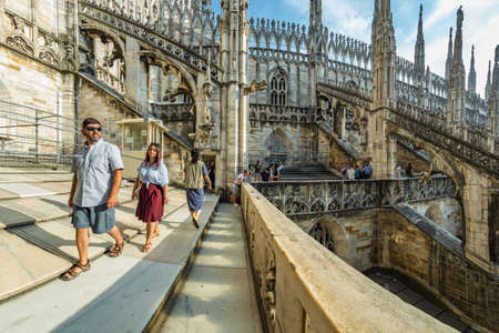 Milan, Italy - Aug 1, 2019: Numerous tourists walk on the observation deck on the roof of Milan Cathedral - Duomo di Milano, Lombardy, Italy.のeditorial素材