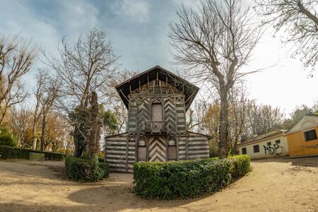 Toledo, Spain - Dec 17, 2018: Old wood house, covered by bark surrounded by the bare winter trees in the center of Park La Vega in Toledo city, Spain, Europe.の写真素材
