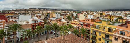 The top of highest church tower. Wide angle panorama of the historic town of San Cristobal de La Laguna in Tenerife showing streets and tiled roofs of historic buildings and horizon in the backgroundの写真素材
