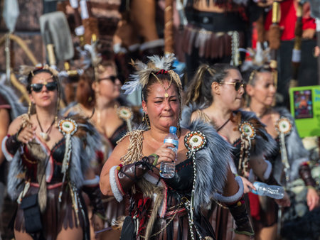 SANTA CRUZ DE TENERIFE, SPAIN - FEBRUARY 13, 2024: The Coso parade, Cavalcada - along the Avenida de Anaga, official end of Carnival. Amazing warm evening, joyful people in carnival costumes have fun.のeditorial素材
