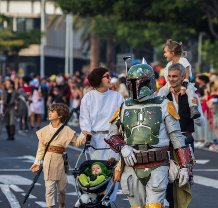 SANTA CRUZ DE TENERIFE, SPAIN - FEBRUARY 13, 2024: The Coso parade, Cavalcada - along the Avenida de Anaga, official end of Carnival. Amazing warm evening, joyful people in carnival costumes have fun.のeditorial素材
