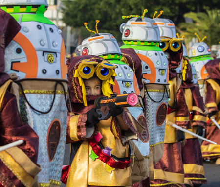 SANTA CRUZ DE TENERIFE, SPAIN - FEBRUARY 13, 2024: The Coso parade, Cavalcada - along the Avenida de Anaga, official end of Carnival. Amazing warm evening, joyful people in carnival costumes have fun.のeditorial素材