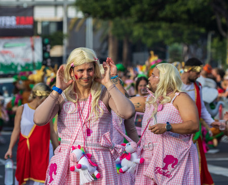 SANTA CRUZ DE TENERIFE, SPAIN - FEBRUARY 13, 2024: The Coso parade, Cavalcada - along the Avenida de Anaga, official end of Carnival. Amazing warm evening, joyful people in carnival costumes have fun.のeditorial素材