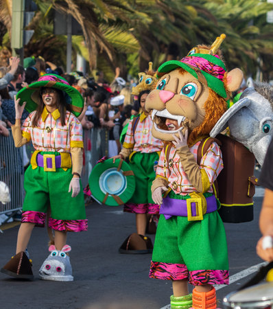 SANTA CRUZ DE TENERIFE, SPAIN - FEBRUARY 13, 2024: The Coso parade, Cavalcada - along the Avenida de Anaga, official end of Carnival. Amazing warm evening, joyful people in carnival costumes have fun.のeditorial素材