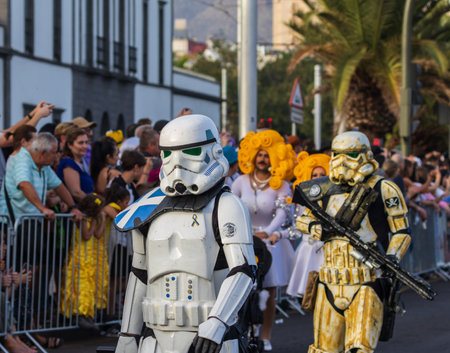 SANTA CRUZ DE TENERIFE, SPAIN - FEBRUARY 13, 2024: The Coso parade, Cavalcada - along the Avenida de Anaga, official end of Carnival. Amazing warm evening, joyful people in carnival costumes have fun.のeditorial素材