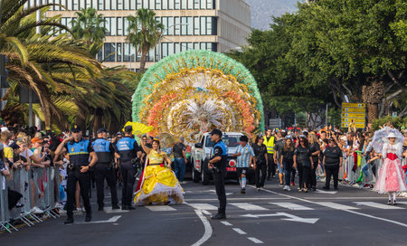 SANTA CRUZ DE TENERIFE, SPAIN - FEBRUARY 13, 2024: The Coso parade, Cavalcada - along the Avenida de Anaga, official end of Carnival. Amazing warm evening, joyful people in carnival costumes have fun.のeditorial素材