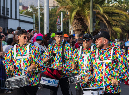 SANTA CRUZ DE TENERIFE, SPAIN - FEBRUARY 13, 2024: The Coso parade, Cavalcada - along the Avenida de Anaga, official end of Carnival. Amazing warm evening, joyful people in carnival costumes have fun.のeditorial素材
