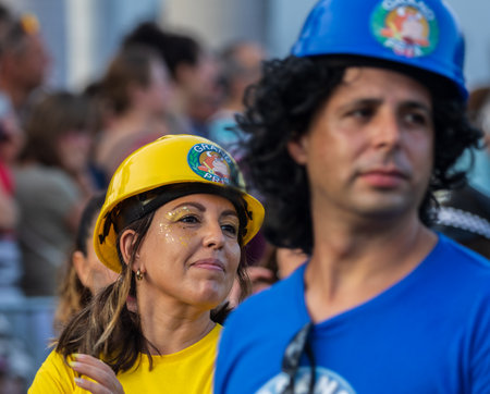 SANTA CRUZ DE TENERIFE, SPAIN - FEBRUARY 13, 2024: The Coso parade, Cavalcada - along the Avenida de Anaga, official end of Carnival. Amazing warm evening, joyful people in carnival costumes have fun.のeditorial素材