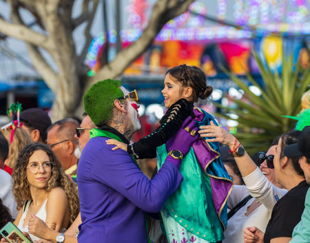 SANTA CRUZ DE TENERIFE, SPAIN - FEBRUARY 13, 2024: The Coso parade, Cavalcada - along the Avenida de Anaga, official end of Carnival. Amazing warm evening, joyful people in carnival costumes have fun.のeditorial素材