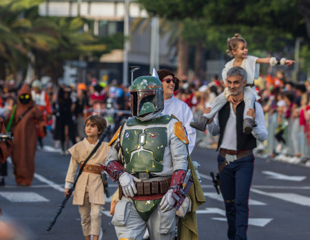 SANTA CRUZ DE TENERIFE, SPAIN - FEBRUARY 13, 2024: The Coso parade, Cavalcada - along the Avenida de Anaga, official end of Carnival. Amazing warm evening, joyful people in carnival costumes have fun.のeditorial素材