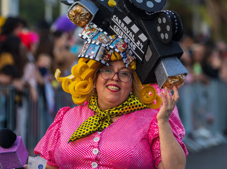 SANTA CRUZ DE TENERIFE, SPAIN - FEBRUARY 13, 2024: The Coso parade, Cavalcada - along the Avenida de Anaga, official end of Carnival. Amazing warm evening, joyful people in carnival costumes have fun.のeditorial素材