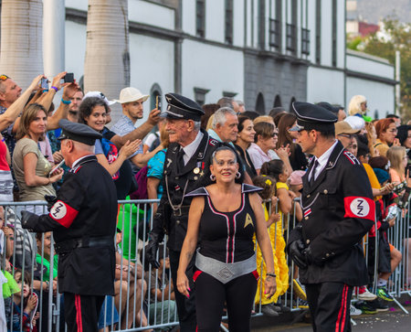 SANTA CRUZ DE TENERIFE, SPAIN - FEBRUARY 13, 2024: The Coso parade, Cavalcada - along the Avenida de Anaga, official end of Carnival. Amazing warm evening, joyful people in carnival costumes have fun.のeditorial素材