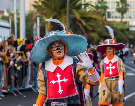 SANTA CRUZ DE TENERIFE, SPAIN - FEBRUARY 13, 2024: The Coso parade, Cavalcada - along the Avenida de Anaga, official end of Carnival. Amazing warm evening, joyful people in carnival costumes have fun.のeditorial素材