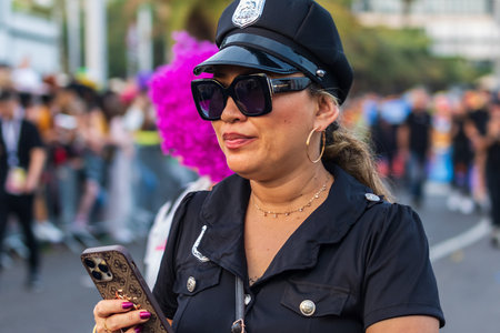 SANTA CRUZ DE TENERIFE, SPAIN - FEBRUARY 13, 2024: The Coso parade, Cavalcada - along the Avenida de Anaga, official end of Carnival. Amazing warm evening, joyful people in carnival costumes have fun.のeditorial素材