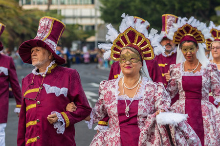 SANTA CRUZ DE TENERIFE, SPAIN - FEBRUARY 13, 2024: The Coso parade, Cavalcada - along the Avenida de Anaga, official end of Carnival. Amazing warm evening, joyful people in carnival costumes have fun.のeditorial素材