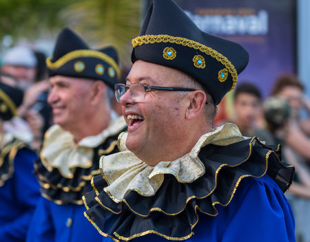 SANTA CRUZ DE TENERIFE, SPAIN - FEBRUARY 13, 2024: The Coso parade, Cavalcada - along the Avenida de Anaga, official end of Carnival. Amazing warm evening, joyful people in carnival costumes have fun.のeditorial素材