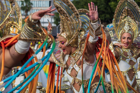 SANTA CRUZ DE TENERIFE, SPAIN - FEBRUARY 13, 2024: The Coso parade, Cavalcada - along the Avenida de Anaga, official end of Carnival. Amazing warm evening, joyful people in carnival costumes have fun.のeditorial素材