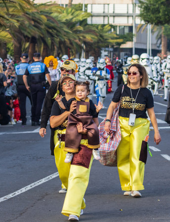SANTA CRUZ DE TENERIFE, SPAIN - FEBRUARY 13, 2024: The Coso parade, Cavalcada - along the Avenida de Anaga, official end of Carnival. Amazing warm evening, joyful people in carnival costumes have fun.のeditorial素材