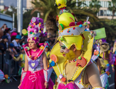 SANTA CRUZ DE TENERIFE, SPAIN - FEBRUARY 13, 2024: The Coso parade, Cavalcada - along the Avenida de Anaga, official end of Carnival. Amazing warm evening, joyful people in carnival costumes have fun.のeditorial素材