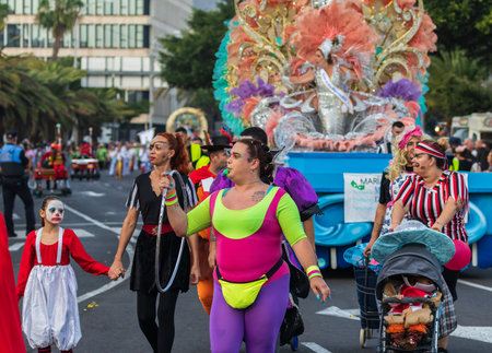 SANTA CRUZ DE TENERIFE, SPAIN - FEBRUARY 13, 2024: The Coso parade, Cavalcada - along the Avenida de Anaga, official end of Carnival. Amazing warm evening, joyful people in carnival costumes have fun.のeditorial素材