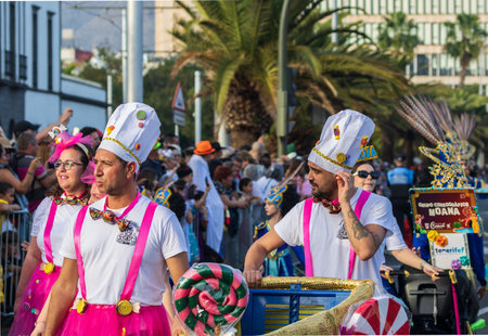SANTA CRUZ DE TENERIFE, SPAIN - FEBRUARY 13, 2024: The Coso parade, Cavalcada - along the Avenida de Anaga, official end of Carnival. Amazing warm evening, joyful people in carnival costumes have fun.のeditorial素材