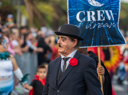 SANTA CRUZ DE TENERIFE, SPAIN - FEBRUARY 13, 2024: The Coso parade, Cavalcada - along the Avenida de Anaga, official end of Carnival. Amazing warm evening, joyful people in carnival costumes have fun.のeditorial素材