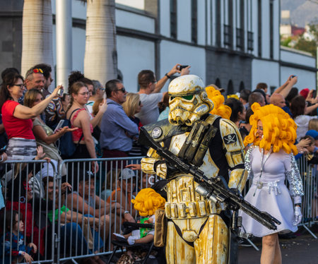 SANTA CRUZ DE TENERIFE, SPAIN - FEBRUARY 13, 2024: The Coso parade, Cavalcada - along the Avenida de Anaga, official end of Carnival. Amazing warm evening, joyful people in carnival costumes have fun.のeditorial素材