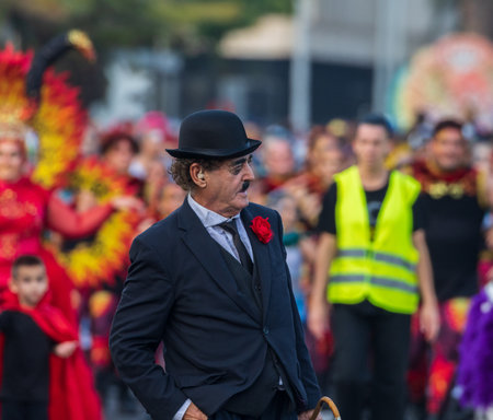 SANTA CRUZ DE TENERIFE, SPAIN - FEBRUARY 13, 2024: The Coso parade, Cavalcada - along the Avenida de Anaga, official end of Carnival. Amazing warm evening, joyful people in carnival costumes have fun.のeditorial素材