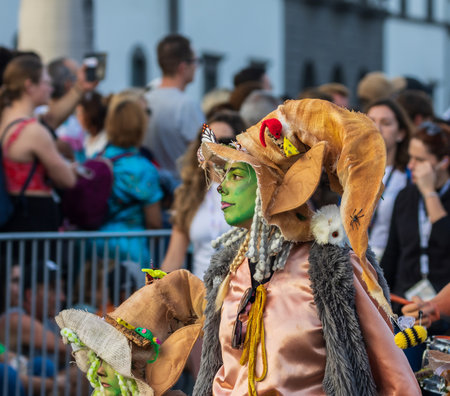 SANTA CRUZ DE TENERIFE, SPAIN - FEBRUARY 13, 2024: The Coso parade, Cavalcada - along the Avenida de Anaga, official end of Carnival. Amazing warm evening, joyful people in carnival costumes have fun.のeditorial素材