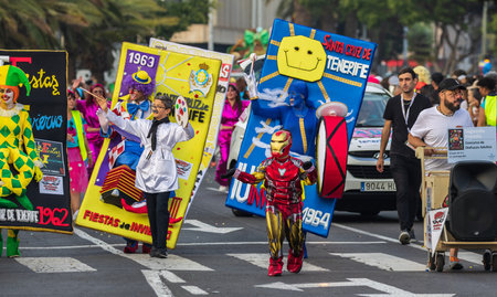 SANTA CRUZ DE TENERIFE, SPAIN - FEBRUARY 13, 2024: The Coso parade, Cavalcada - along the Avenida de Anaga, official end of Carnival. Amazing warm evening, joyful people in carnival costumes have fun.のeditorial素材