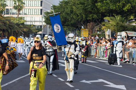 SANTA CRUZ DE TENERIFE, SPAIN - FEBRUARY 13, 2024: The Coso parade, Cavalcada - along the Avenida de Anaga, official end of Carnival. Amazing warm evening, joyful people in carnival costumes have fun.のeditorial素材