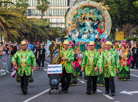 SANTA CRUZ DE TENERIFE, SPAIN - FEBRUARY 13, 2024: The Coso parade, Cavalcada - along the Avenida de Anaga, official end of Carnival. Amazing warm evening, joyful people in carnival costumes have fun.のeditorial素材