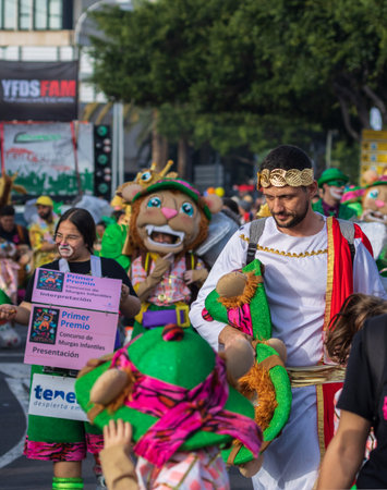 SANTA CRUZ DE TENERIFE, SPAIN - FEBRUARY 13, 2024: The Coso parade, Cavalcada - along the Avenida de Anaga, official end of Carnival. Amazing warm evening, joyful people in carnival costumes have fun.のeditorial素材