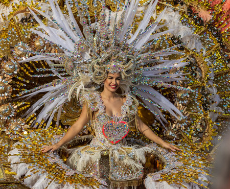 SANTA CRUZ DE TENERIFE, SPAIN - FEBRUARY 13, 2024: The Coso parade, Cavalcada - along the Avenida de Anaga, official end of Carnival. Amazing warm evening, joyful people in carnival costumes have fun.のeditorial素材