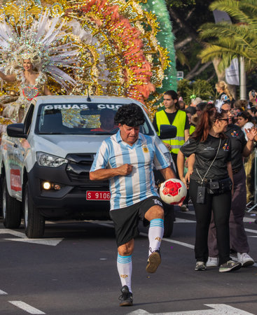 SANTA CRUZ DE TENERIFE, SPAIN - FEBRUARY 13, 2024: The Coso parade, Cavalcada - along the Avenida de Anaga, official end of Carnival. Amazing warm evening, joyful people in carnival costumes have fun.のeditorial素材