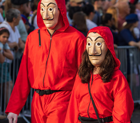 SANTA CRUZ DE TENERIFE, SPAIN - FEBRUARY 13, 2024: The Coso parade, Cavalcada - along the Avenida de Anaga, official end of Carnival. Amazing warm evening, joyful people in carnival costumes have fun.のeditorial素材