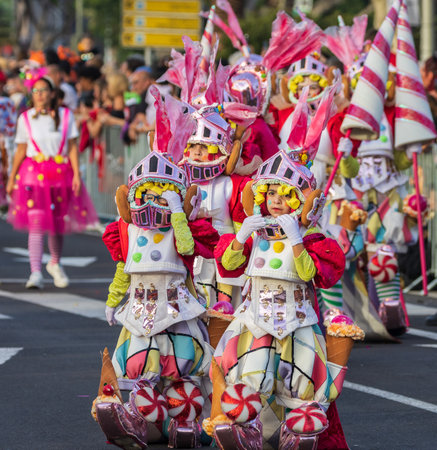 SANTA CRUZ DE TENERIFE, SPAIN - FEBRUARY 13, 2024: The Coso parade, Cavalcada - along the Avenida de Anaga, official end of Carnival. Amazing warm evening, joyful people in carnival costumes have fun.のeditorial素材