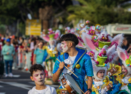 SANTA CRUZ DE TENERIFE, SPAIN - FEBRUARY 13, 2024: The Coso parade, Cavalcada - along the Avenida de Anaga, official end of Carnival. Amazing warm evening, joyful people in carnival costumes have fun.のeditorial素材