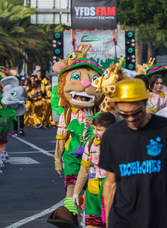 SANTA CRUZ DE TENERIFE, SPAIN - FEBRUARY 13, 2024: The Coso parade, Cavalcada - along the Avenida de Anaga, official end of Carnival. Amazing warm evening, joyful people in carnival costumes have fun.のeditorial素材